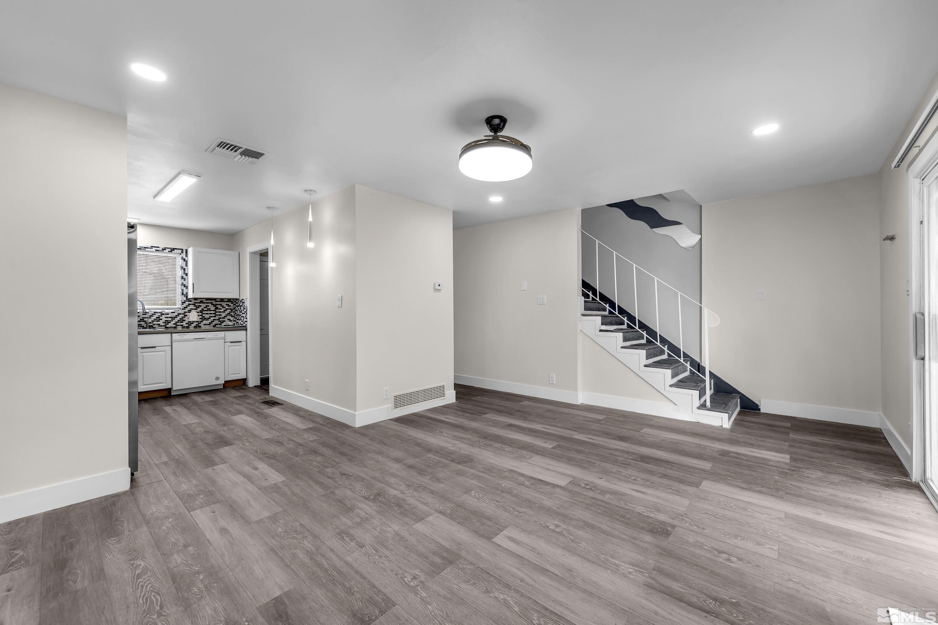 4 Smithridge Park Reno, NV 89502 - Photo 16 of 26 an empty room with wooden floor and a ceiling fan