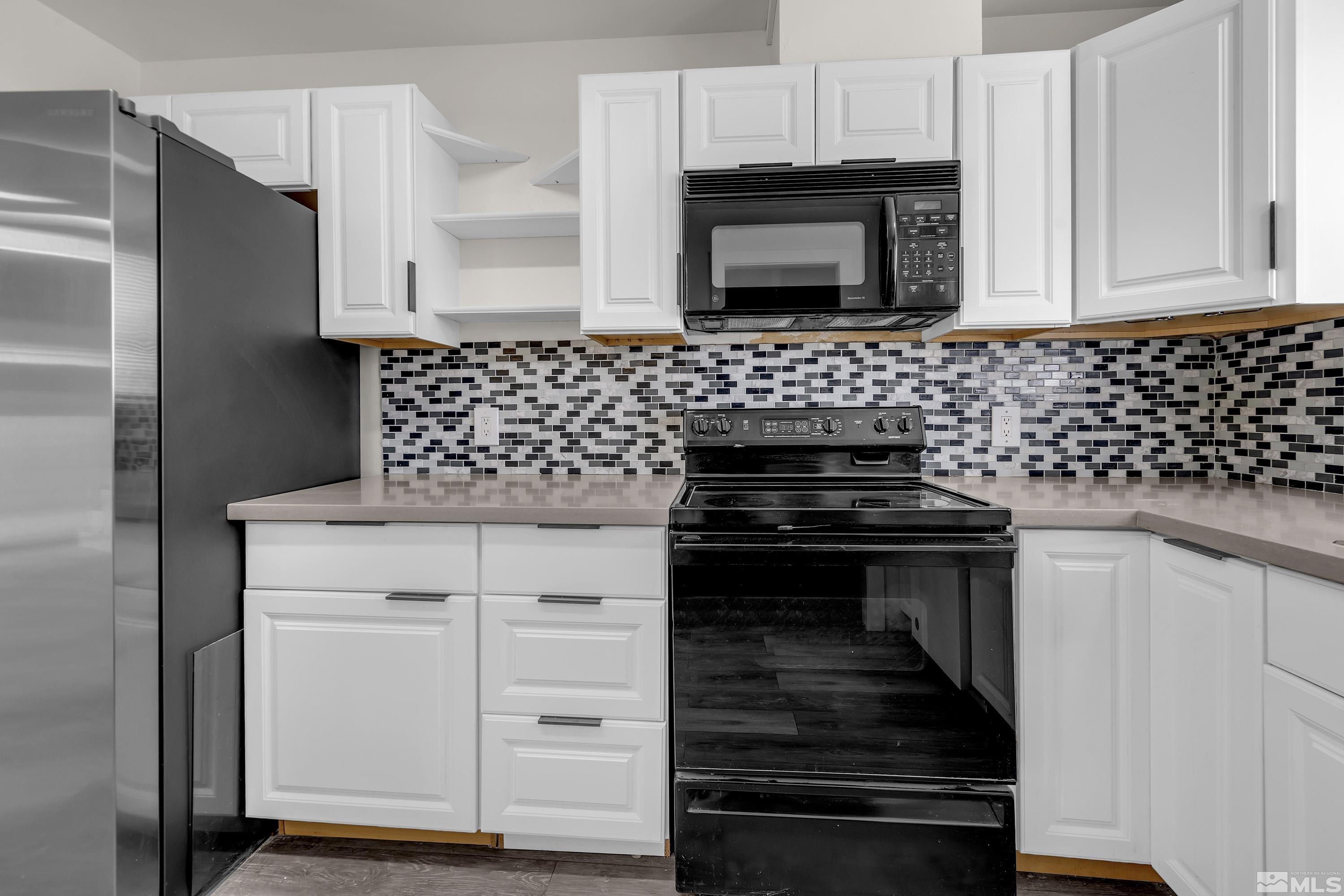 4 Smithridge Park Reno, NV 89502 - Photo 20 of 26 a kitchen with granite countertop white cabinets and stainless steel appliances