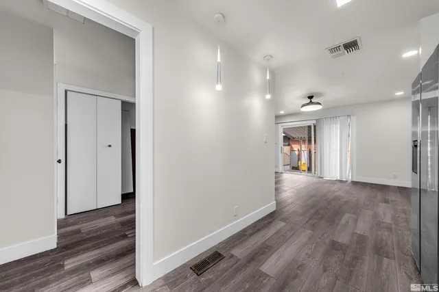 a view of a hallway with wooden floor