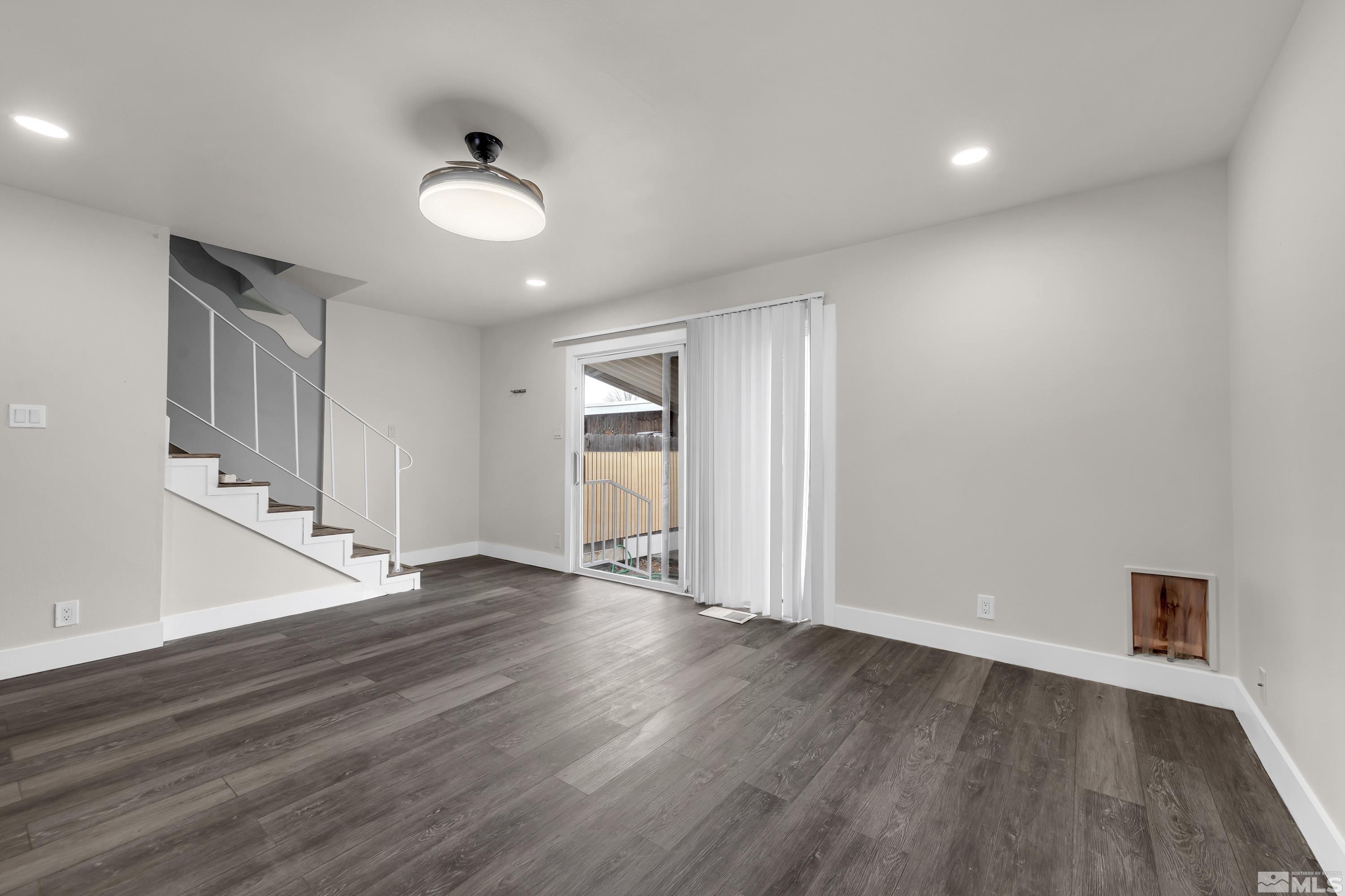 4 Smithridge Park Reno, NV 89502 - Photo 23 of 26 an empty room with wooden floor and windows