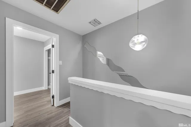 a view of staircase with wooden floor