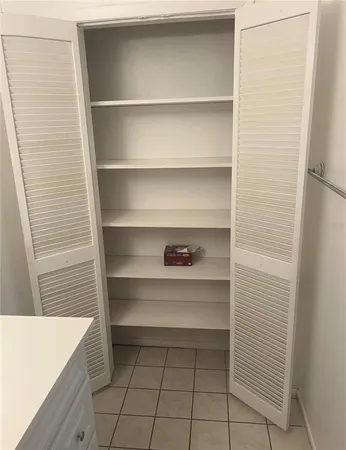 a bathroom with a granite countertop bathtub and toilet