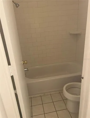 a bathroom with a shower a toilet and a shower