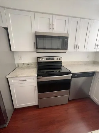 a kitchen with a stove and a microwave