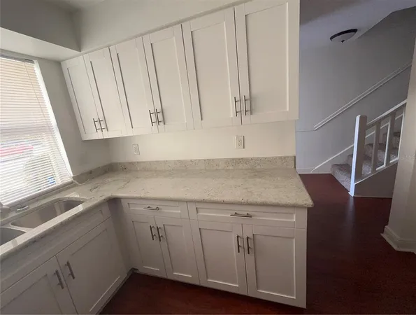 a kitchen with a sink and cabinets