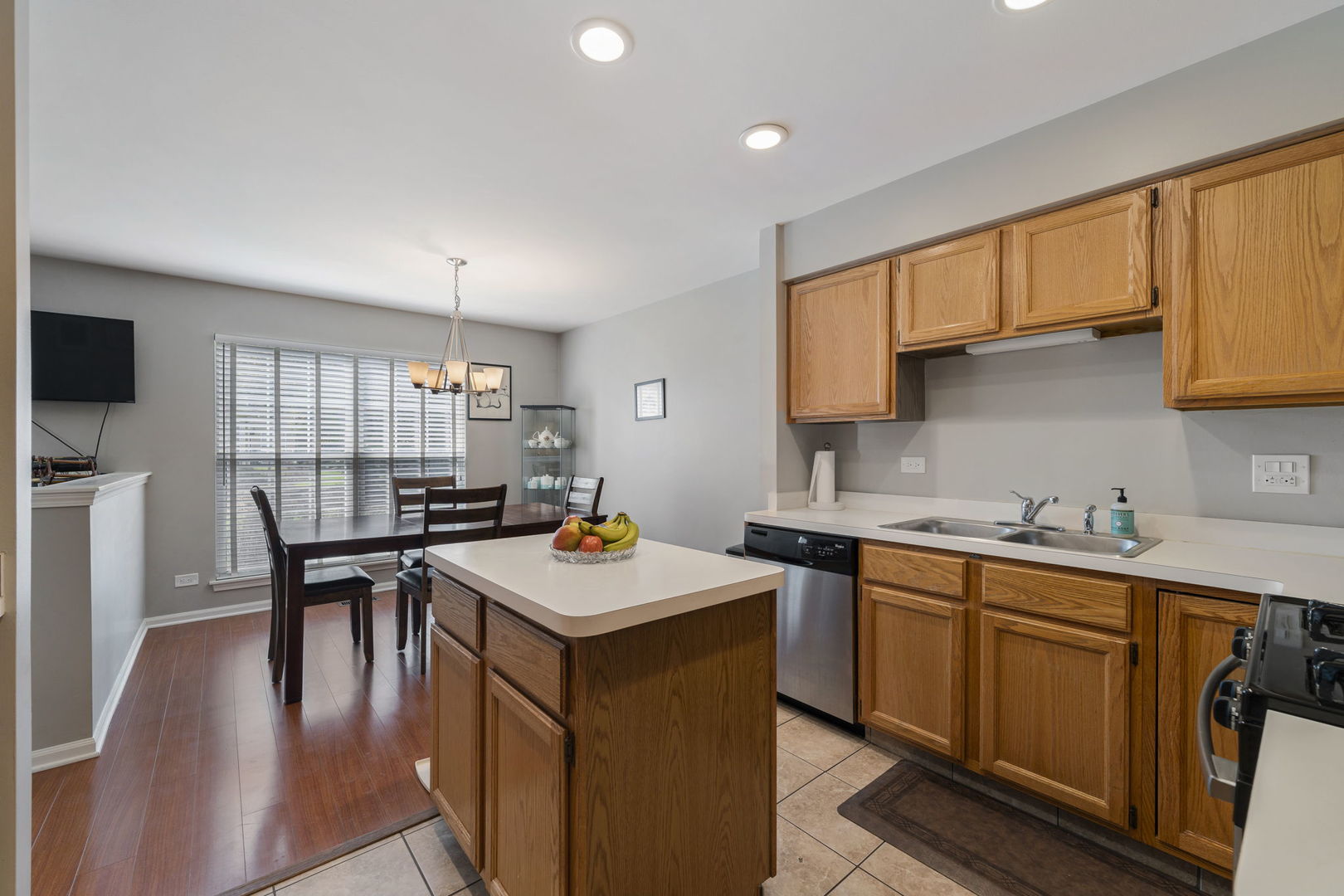 36132 North Springbrook Lane Gurnee, IL 60031 - Photo 14 of 30 a kitchen with a sink a stove a table and chairs