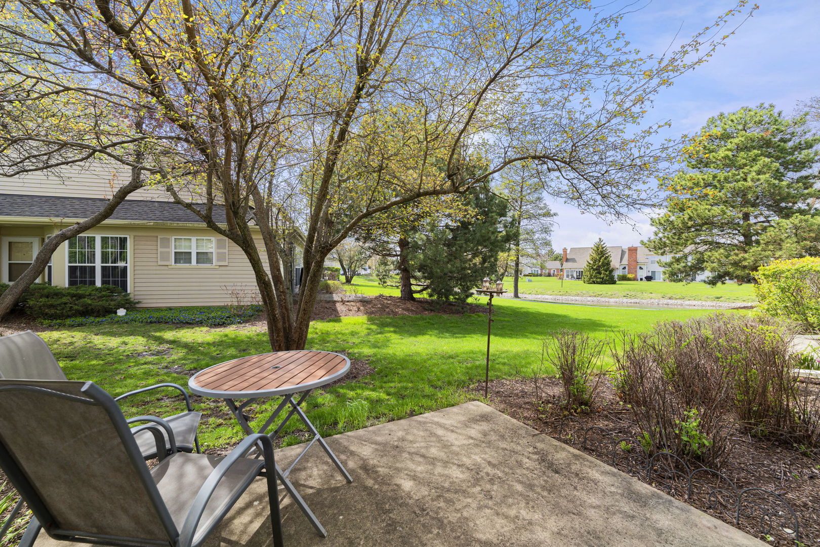 36132 North Springbrook Lane Gurnee, IL 60031 - Photo 9 of 30 a view of a backyard with table and chairs under an umbrella