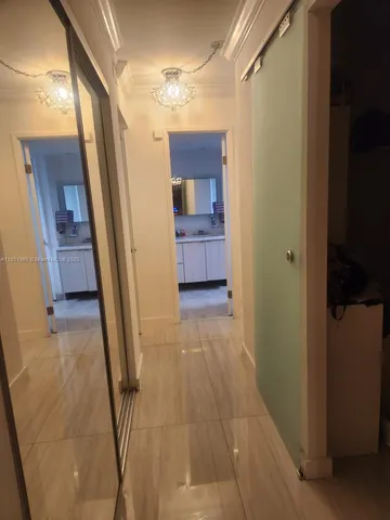 a view of a hallway with a livingroom and furniture