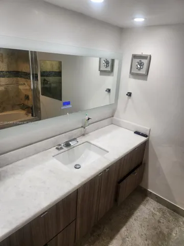 a bathroom with a sink and a mirror