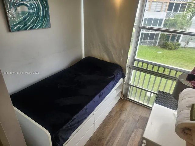 a balcony with wooden floor and furniture