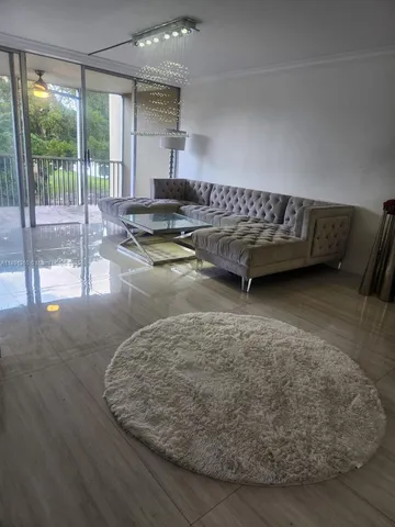 a living room with a couch and wooden floor