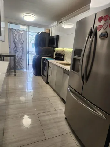 a kitchen with granite countertop a refrigerator and a stove