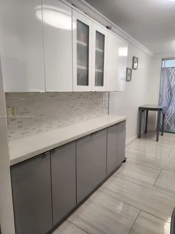 a kitchen with a sink and cabinets