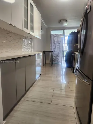 a view of entryway and kitchen