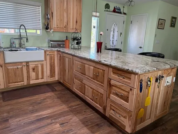 a kitchen with stainless steel appliances granite countertop a sink stove and cabinets