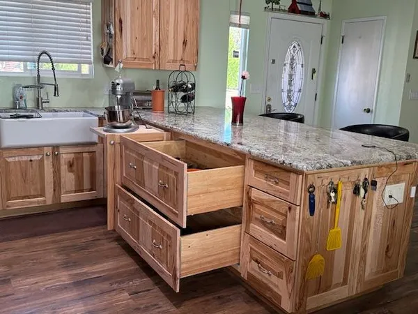 a kitchen with stainless steel appliances granite countertop a sink and cabinets