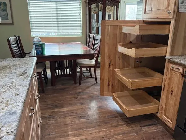 a dining room with a wooden table and chairs