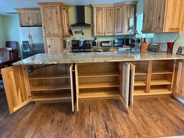 a kitchen with wooden floors and a sink