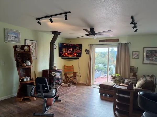 a view of a livingroom with workspace and a window