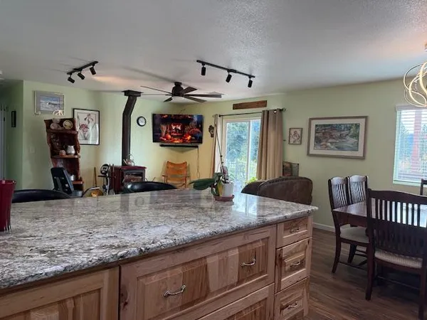 a living room with granite countertop furniture and a wooden floor