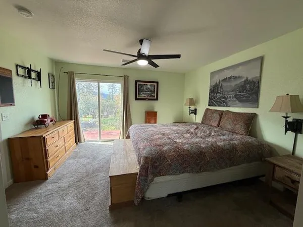 a bedroom with a large bed and a chandelier