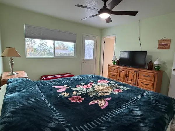 a bedroom with bed and flat screen tv