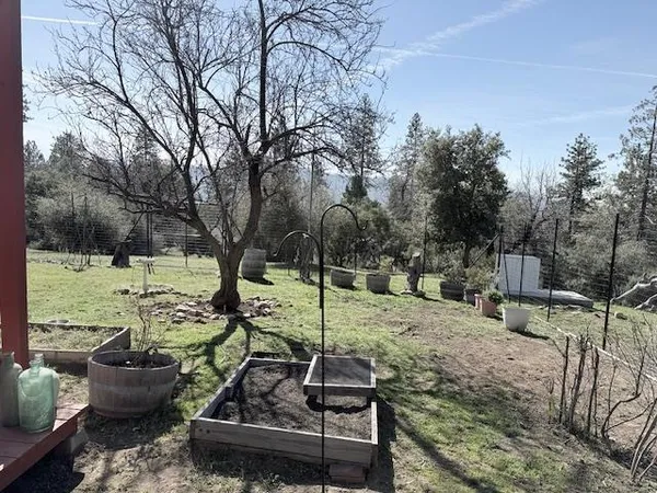 a view of a house with backyard and sitting area