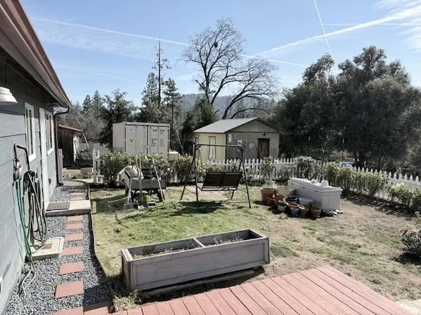 a view of a house with backyard and sitting area