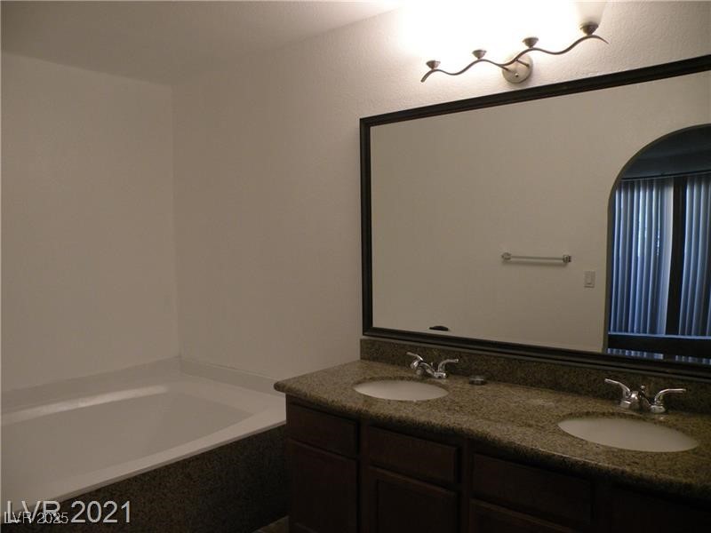 1844 North Decatur Boulevard, Unit 103 Las Vegas, NV 89108 - Photo 8 of 9 Bathroom with a garden tub and double vanity