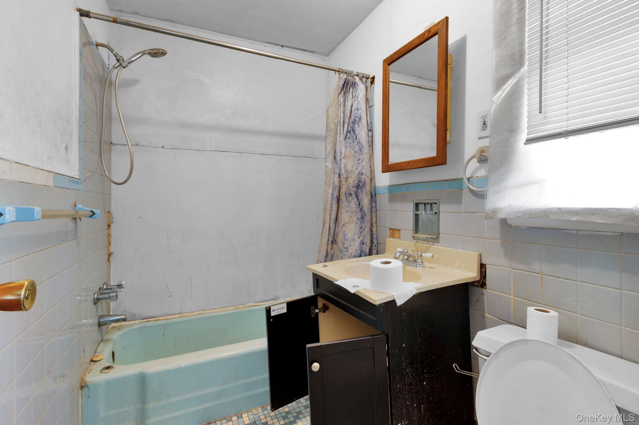 31 Foster Road Cairo, NY 12413 - Photo 17 of 38 a bathroom with a sink vanity tub shower and a mirror