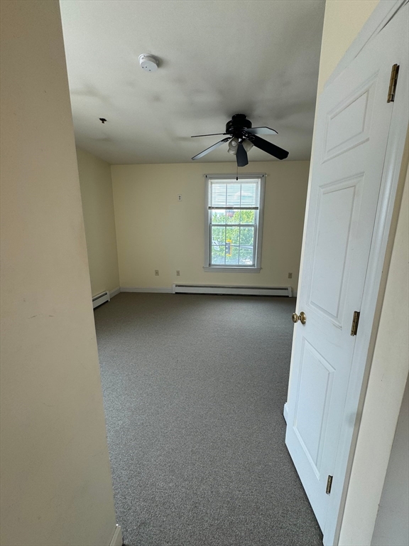 356 East Merrimack Street, Unit 5 Lowell, MA 01852 - Photo 3 of 8 an empty room with windows and entrance