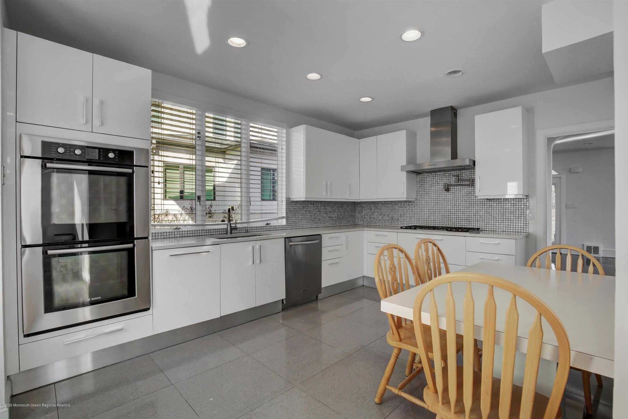 60 Monmouth Drive Deal, NJ 07723 - Photo 13 of 33 a kitchen with granite countertop a stove a sink and a refrigerator