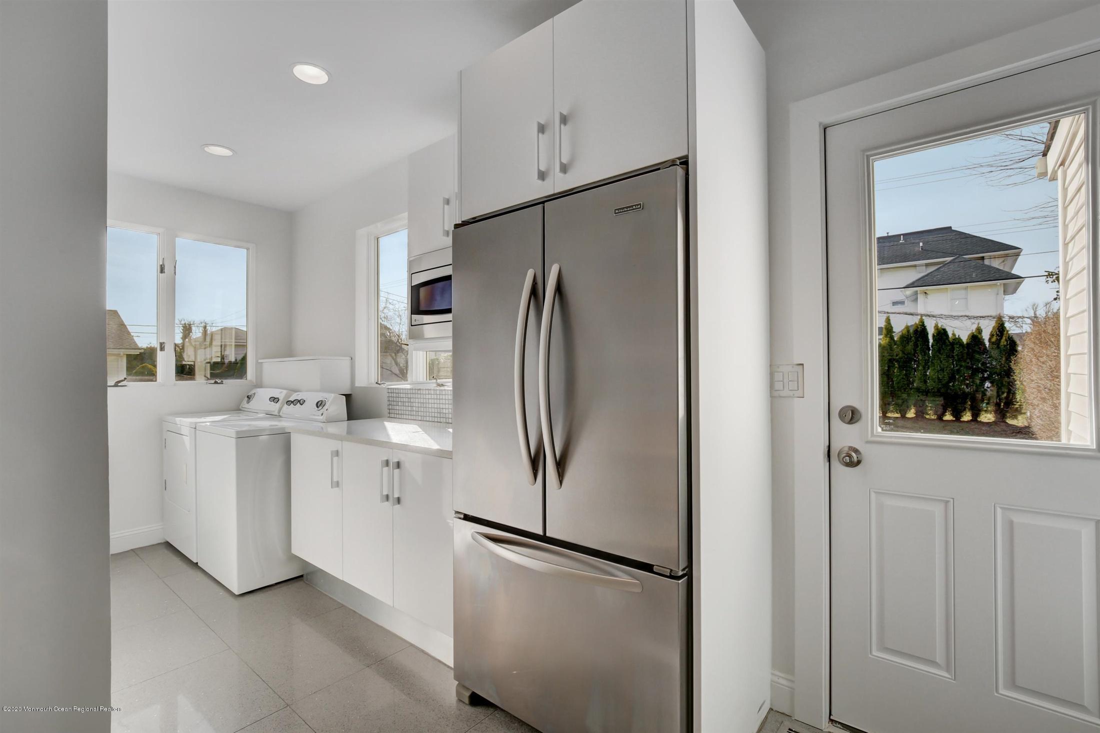 60 Monmouth Drive Deal, NJ 07723 - Photo 15 of 33 a kitchen with white cabinets and refrigerator