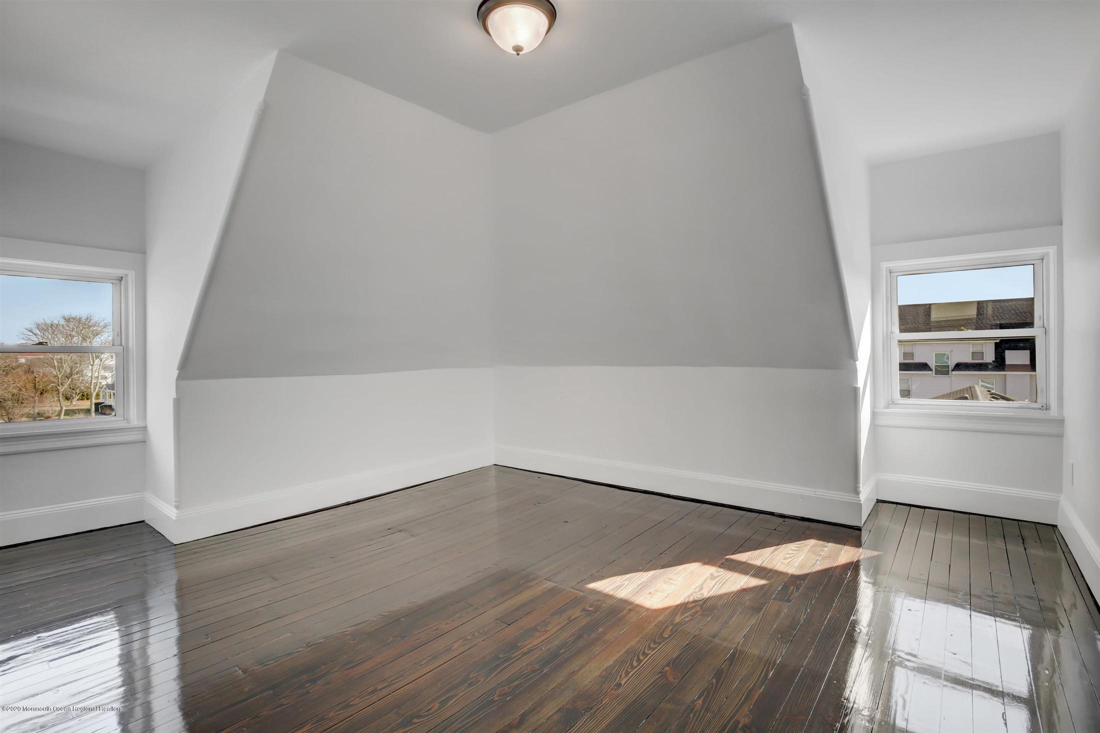 60 Monmouth Drive Deal, NJ 07723 - Photo 21 of 33 wooden floor in an empty room with a window
