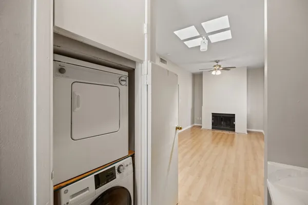 a view of a livingroom with wooden floor and a ceiling fan