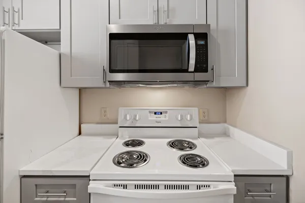 a kitchen with a stove and a microwave
