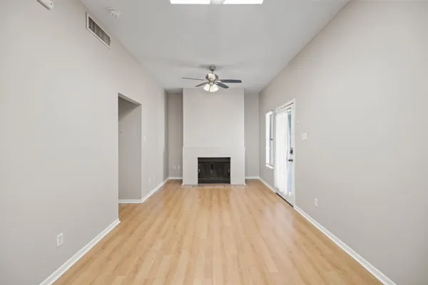 a view of a big room with closet and a fireplace