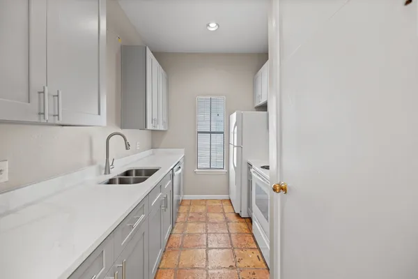 a kitchen with a sink and refrigerator