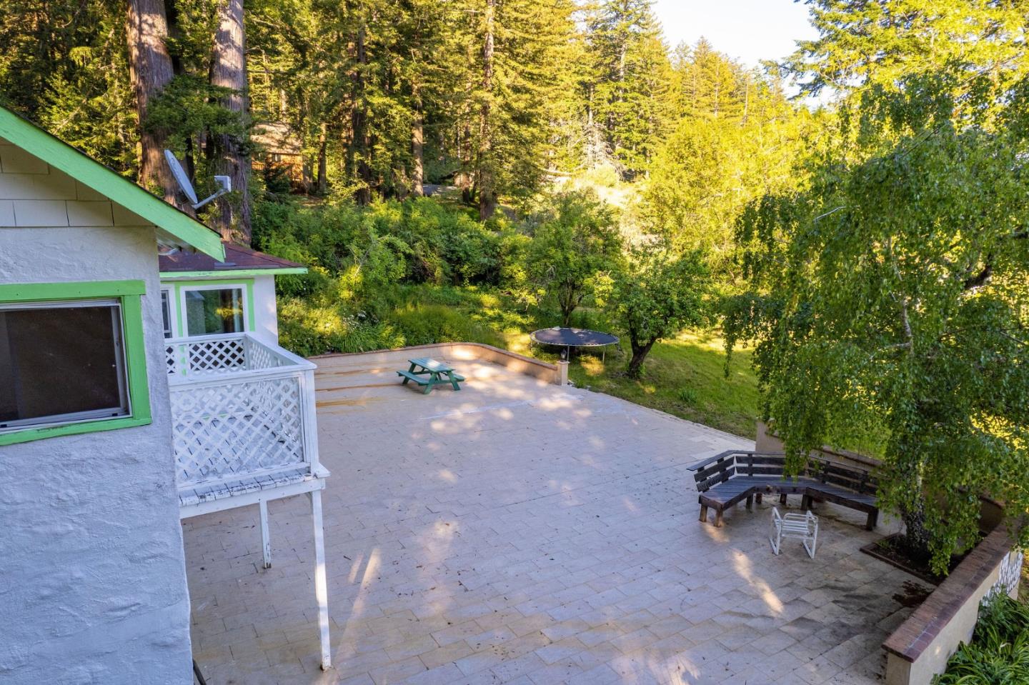 161 Ware Road Woodside, CA 94062 - Photo 19 of 52 a view of a patio with table and chairs with wooden fence and plants