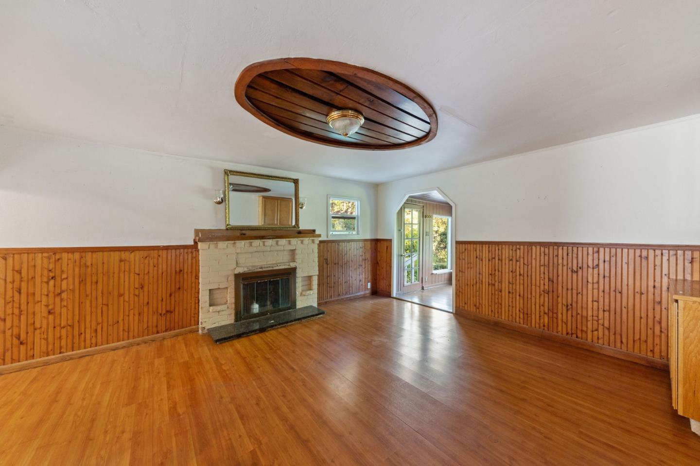 161 Ware Road Woodside, CA 94062 - Photo 27 of 52 an empty room with wooden floor fireplace and windows