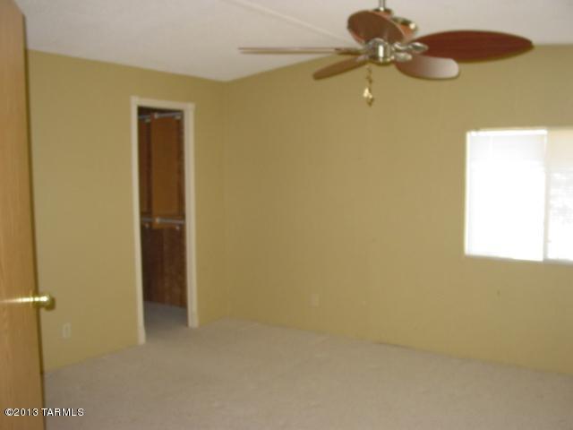 5201 North Lak A Yucca Road Tucson, AZ 85743 - Photo 6 of 19 a view of a room with a ceiling fan and a window