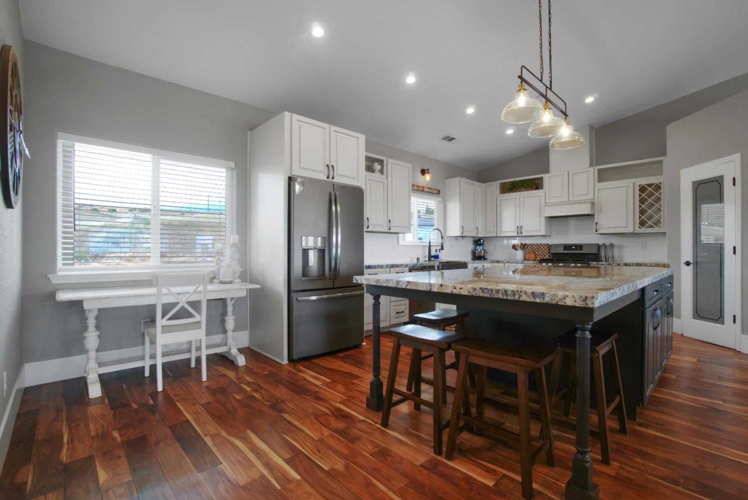 7991 South Shingle Road Shingle Springs, CA 95682 - Photo 10 of 58 a kitchen with stainless steel appliances granite countertop a refrigerator a stove a sink dishwasher a dining table and chairs with wooden floor