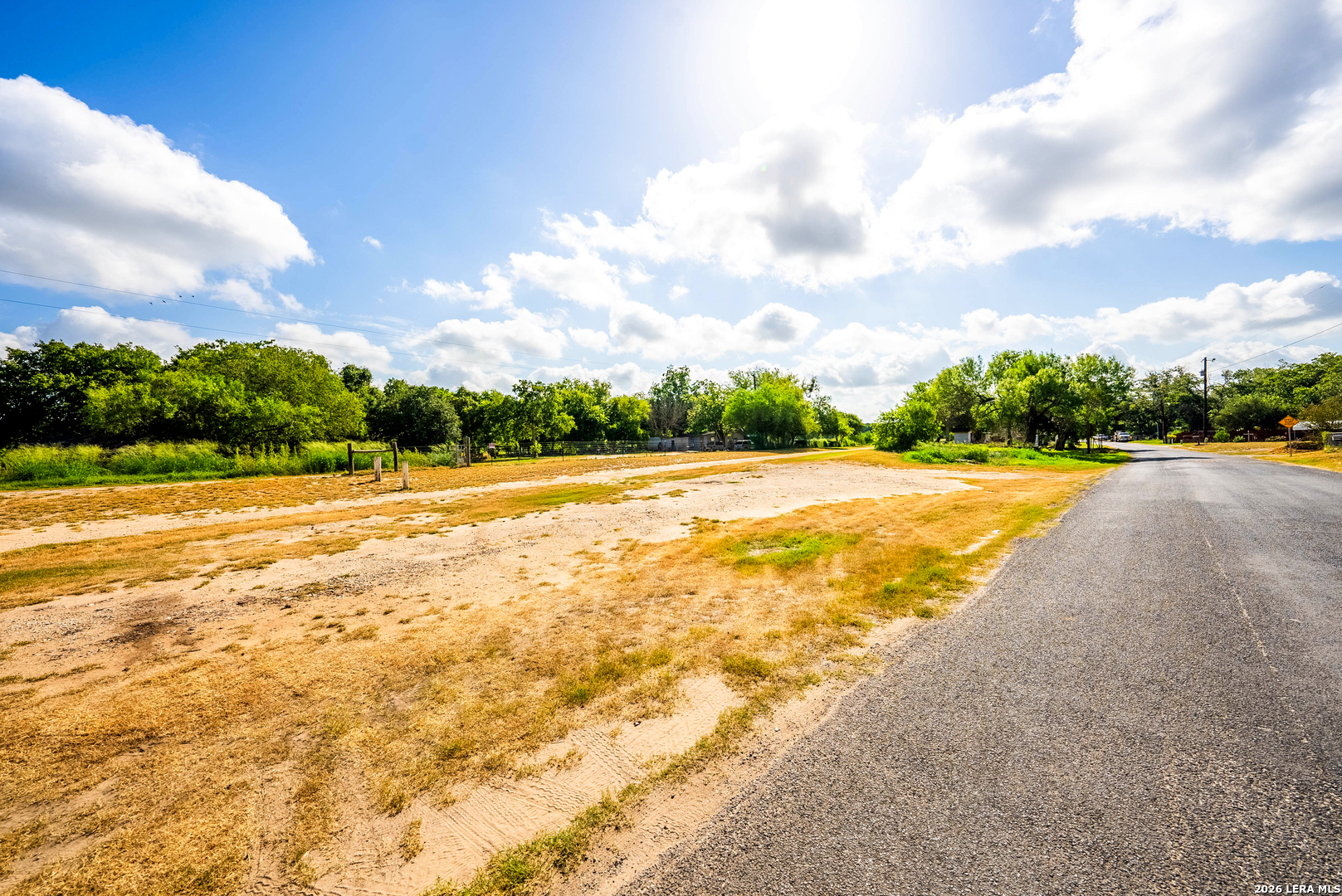 710 Goliad Road Floresville, TX 78114 - Photo 27 of 31 a view of yard with swimming pool and trees in the background
