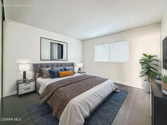 a bedroom with bed and a potted plant