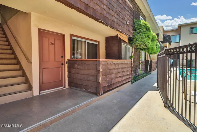a view of backyard with deck and wooden floor