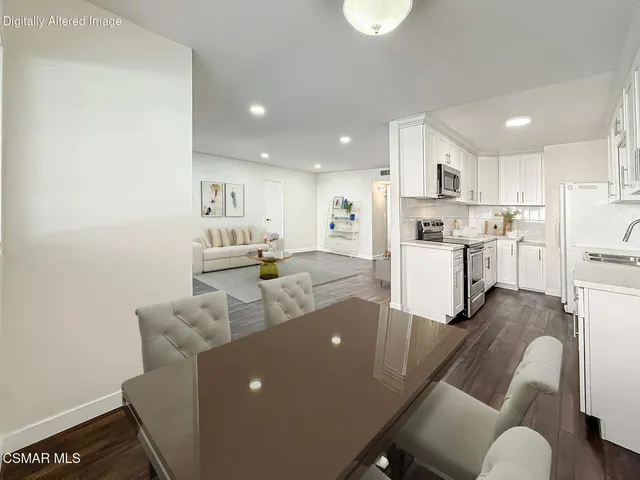 a living room with furniture and kitchen view