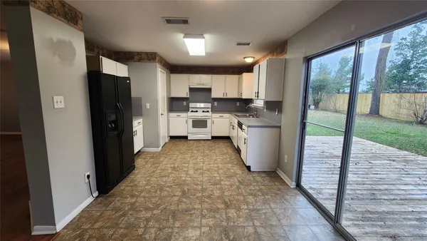 a kitchen with stainless steel appliances granite countertop a refrigerator and a sink
