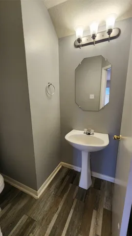 a bathroom with a sink toilet and mirror