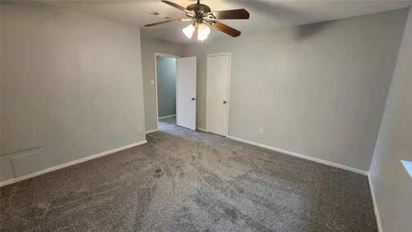 a view of a livingroom with a ceiling fan and window