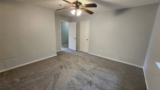 a view of a livingroom with a ceiling fan and window